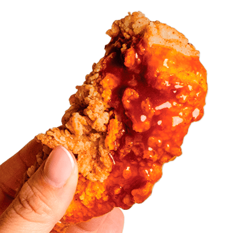 A hand holding a General Tso's chicken finger, a flavorful and juicy specialty at Kung Fu Chicken in South Florida.