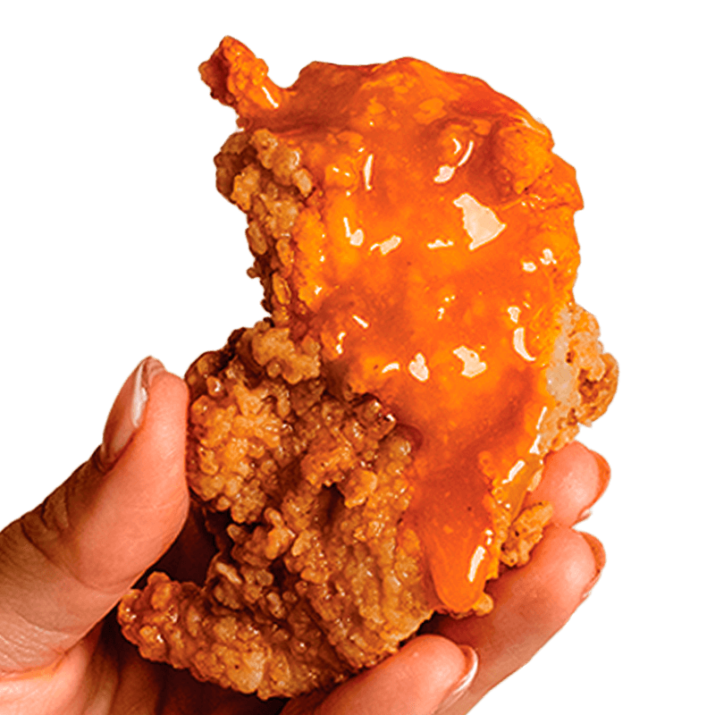 A hand holds a delicious honey garlic chicken finger from Kung Fu Chicken, the best Asian fried chicken in Miami.