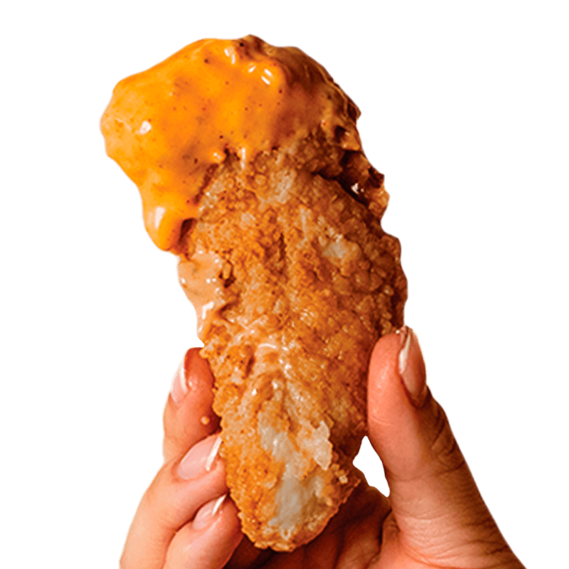 Enjoy our signature Kung Fu Sauce on a crispy chicken finger, a must-try at our Miami Asian fast-food restaurant.