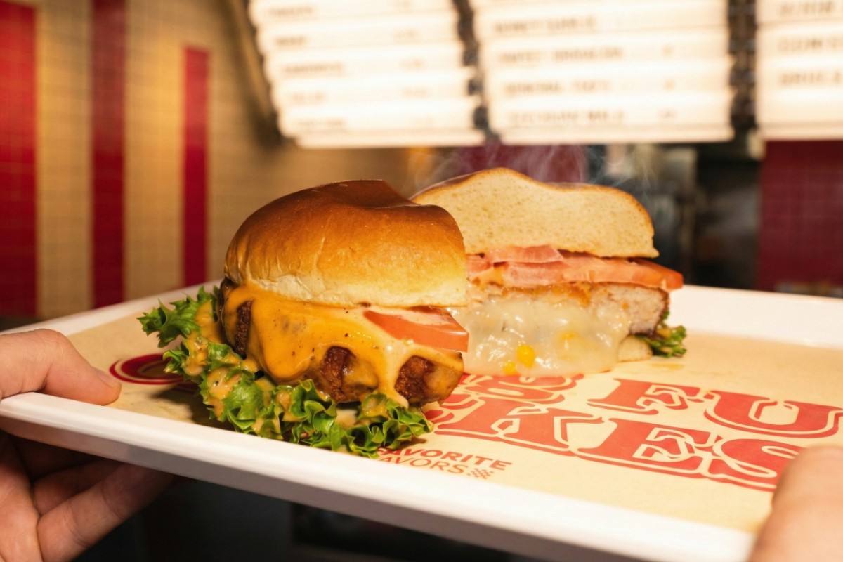 A golden brown crispy panko chicken sandwich stuffed with mozzarella cheese on a toasted brioche bun.